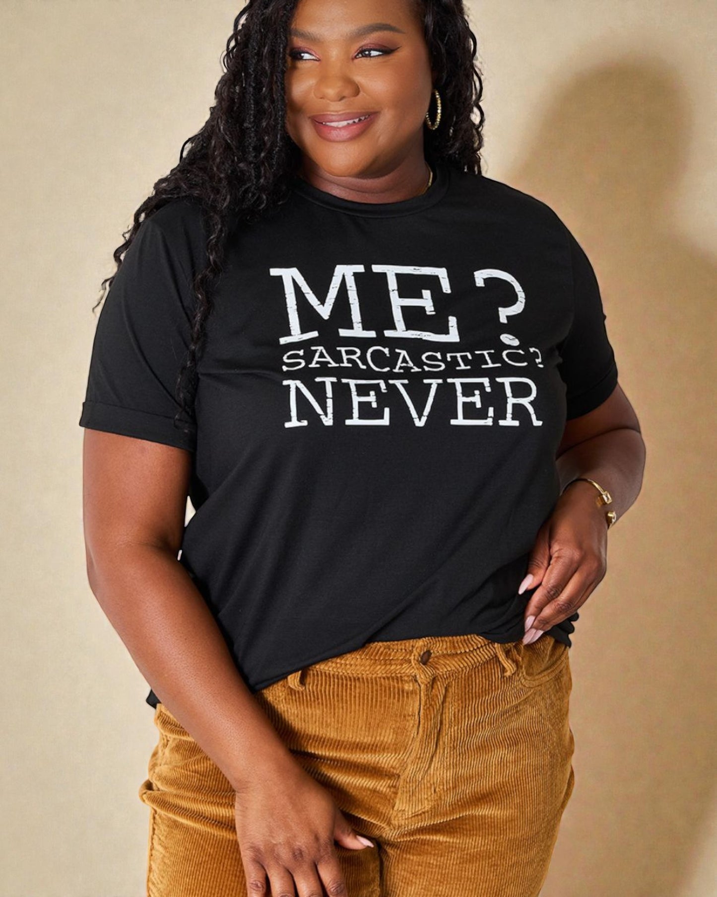 Person wearing a black t-shirt with 'ME? SARCASTIC? NEVER' text on a beige background