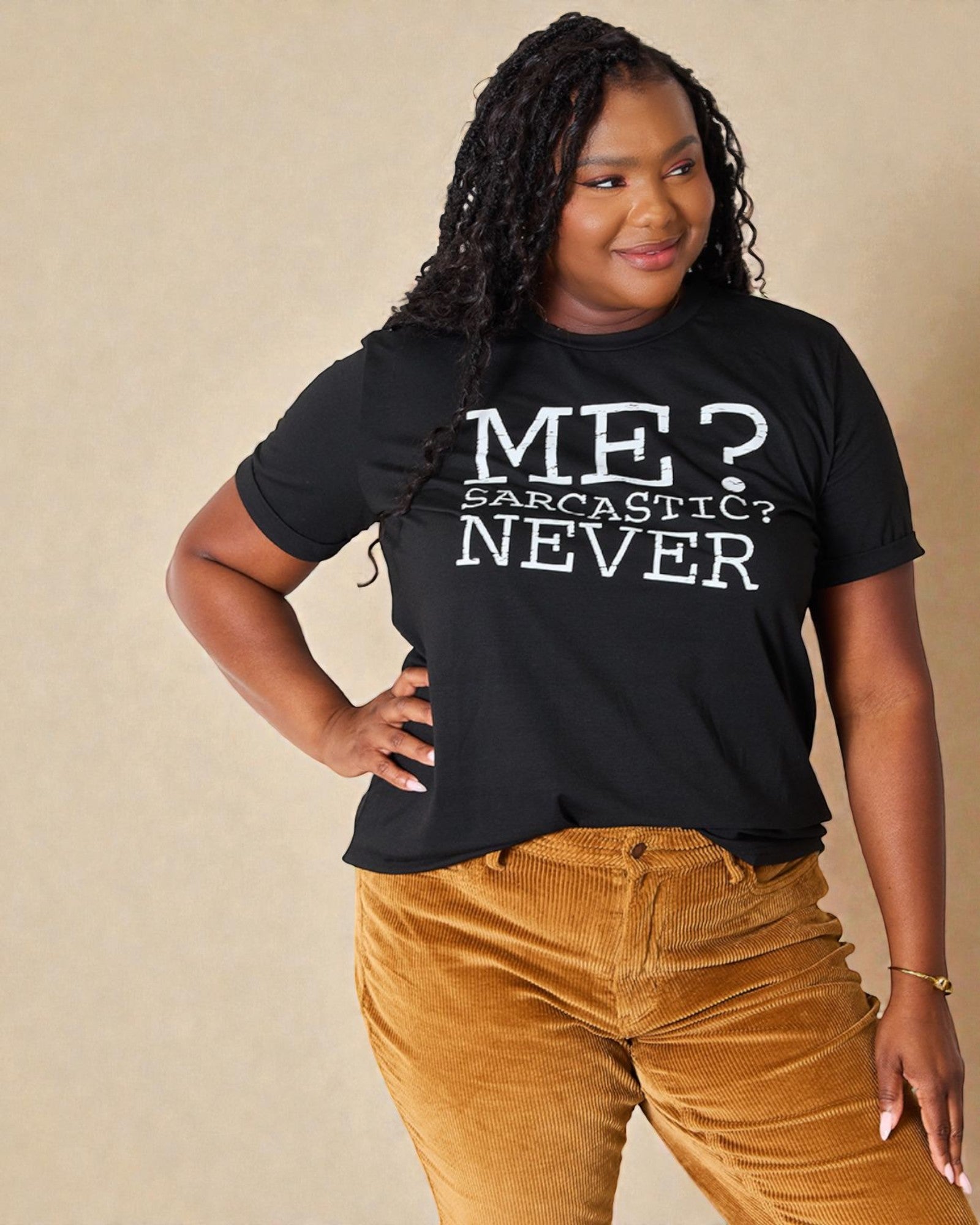 Person wearing a black t-shirt with 'ME? SARCASTIC? NEVER' text on a beige background