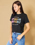 Woman wearing a black t-shirt with colorful text on a beige background