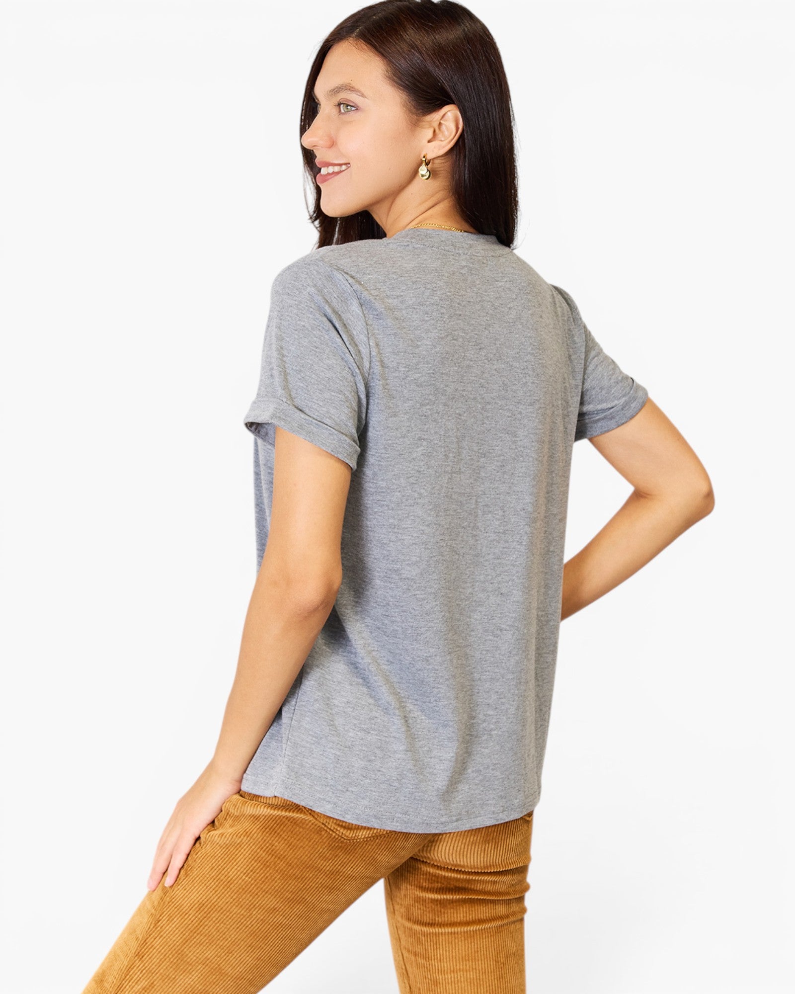 A woman shown from the back wearing a heather gray short-sleeve t-shirt and brown corduroy pants against a plain white studio background.
