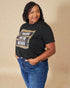 Woman wearing a black t-shirt with 'WIFE MOM BOSS' text on a beige background