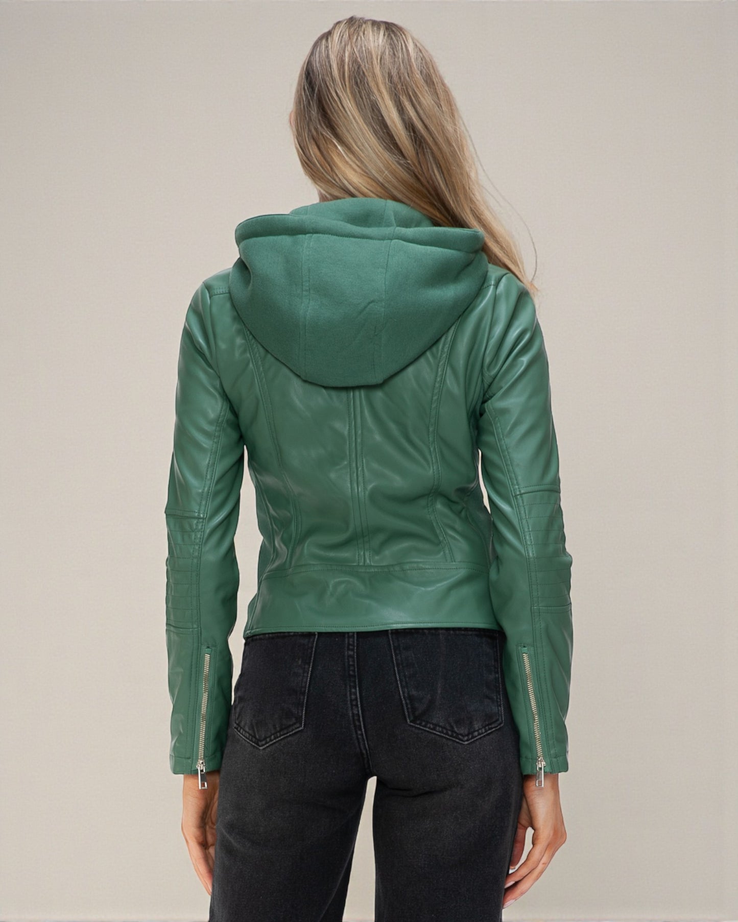Green leather jacket with hood worn by a person on a plain background