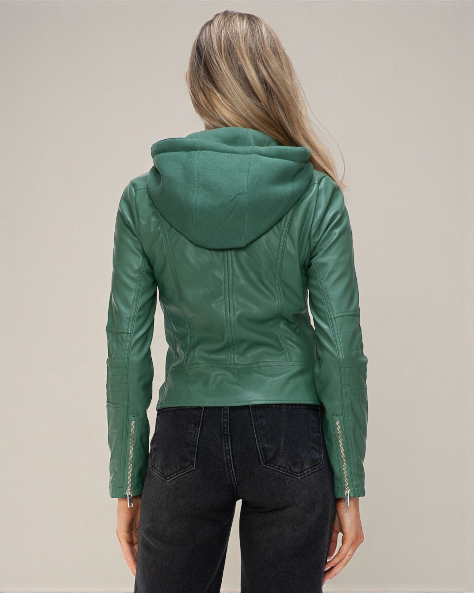Green leather jacket with hood worn by a person on a plain background