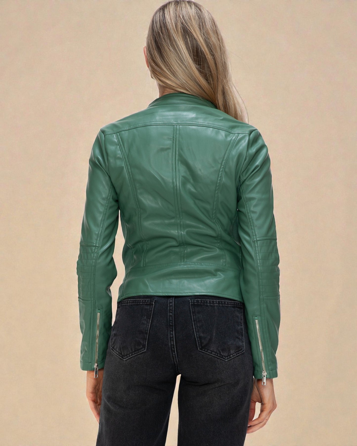 Green leather jacket worn by a person on a beige background