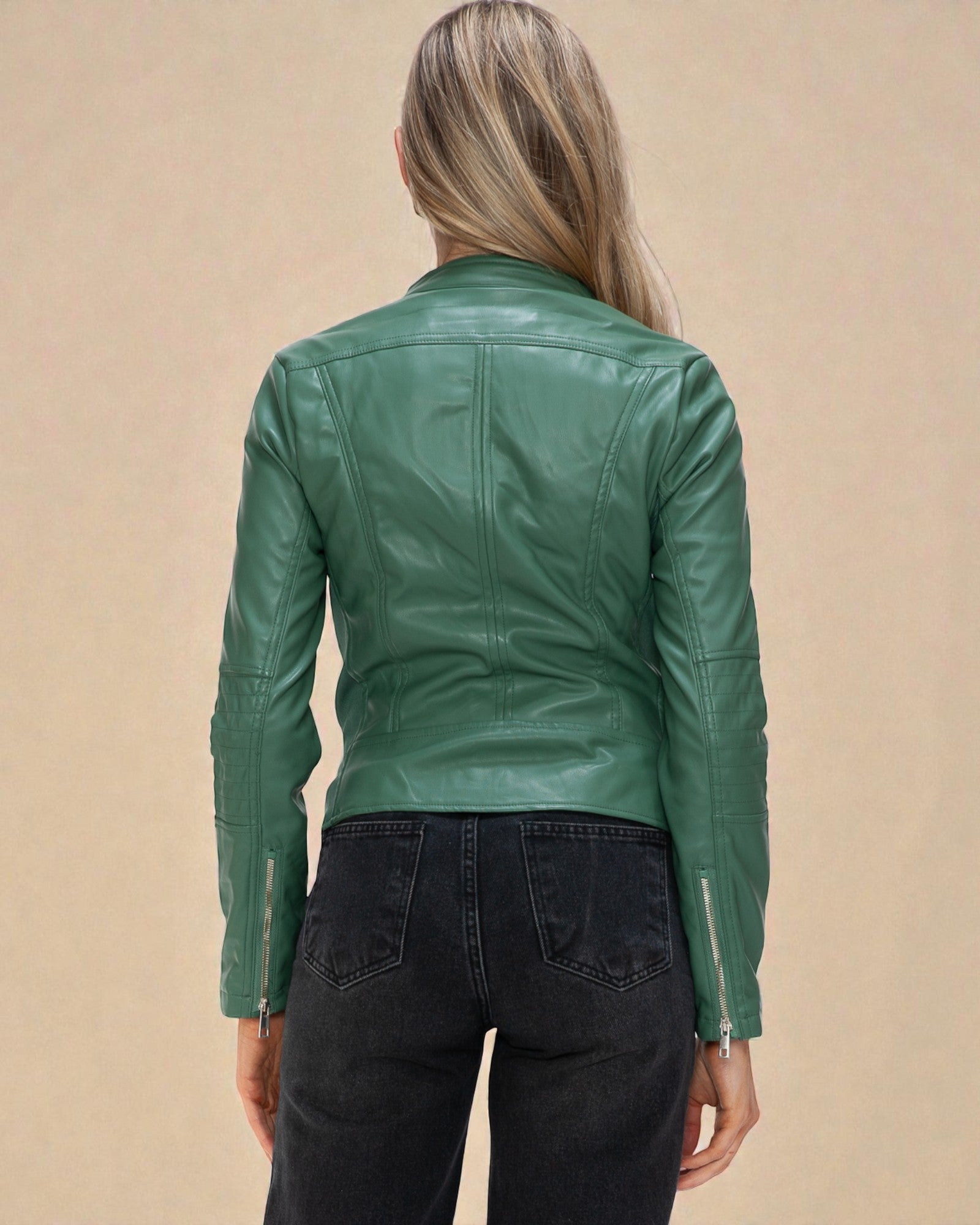 Green leather jacket worn by a person on a beige background