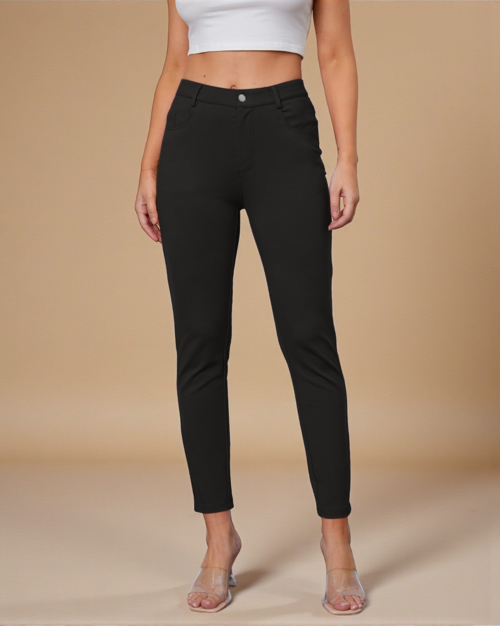 Person wearing black pants on a beige background