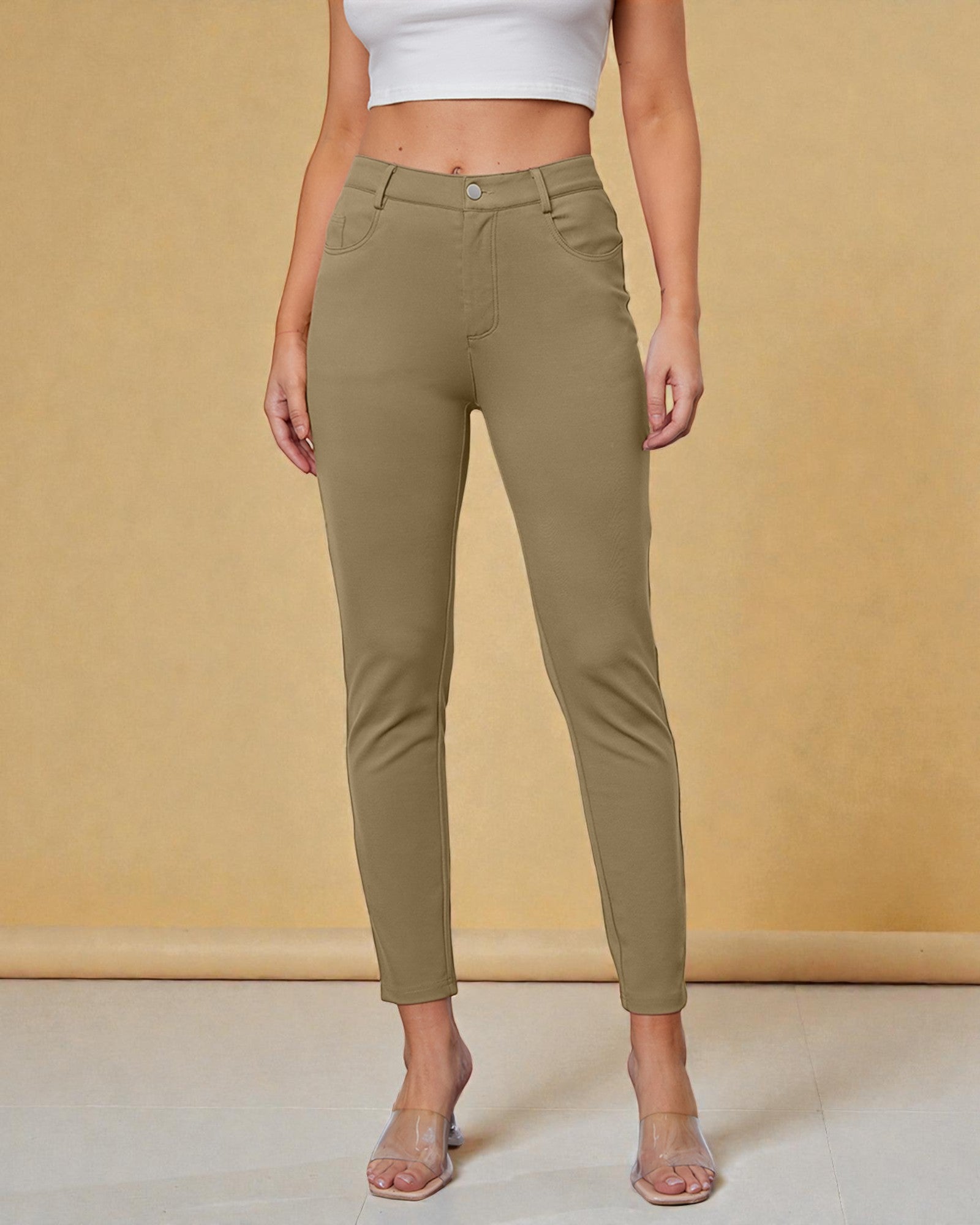 Person wearing olive green pants against a beige background