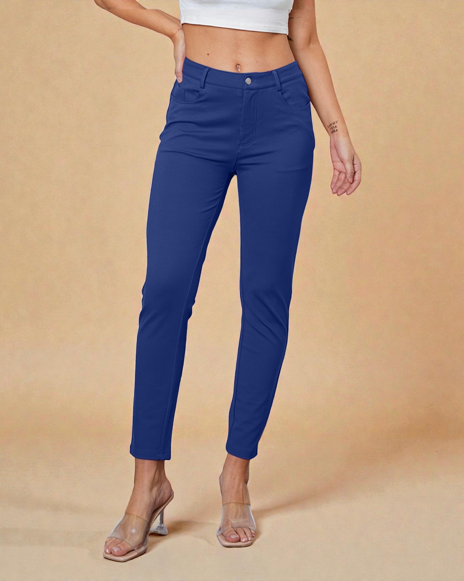 Person wearing blue pants on a beige background