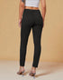 Person wearing black pants on a beige background
