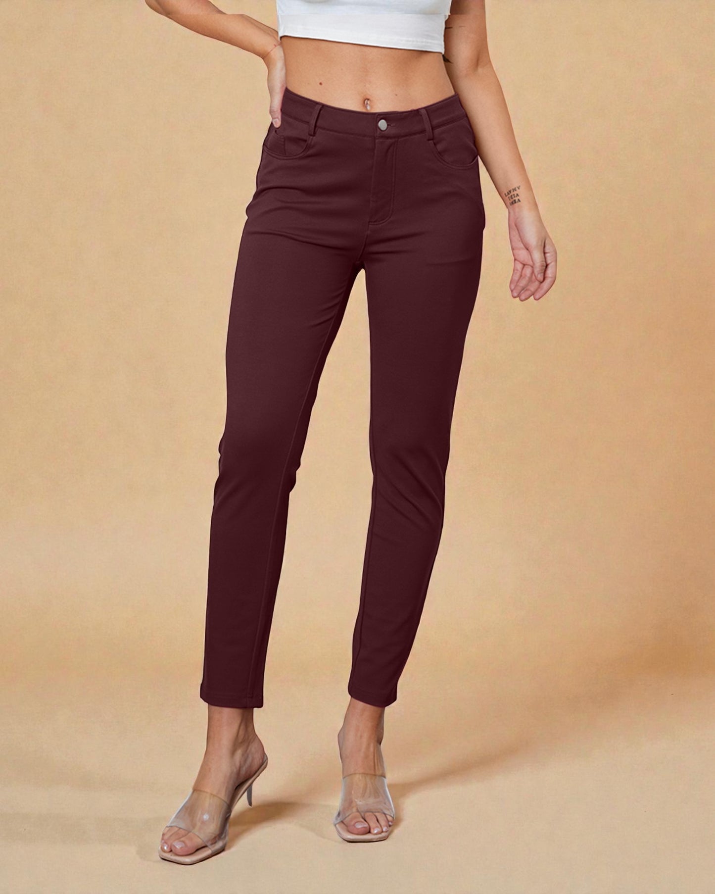 Maroon pants worn by a person on a beige background