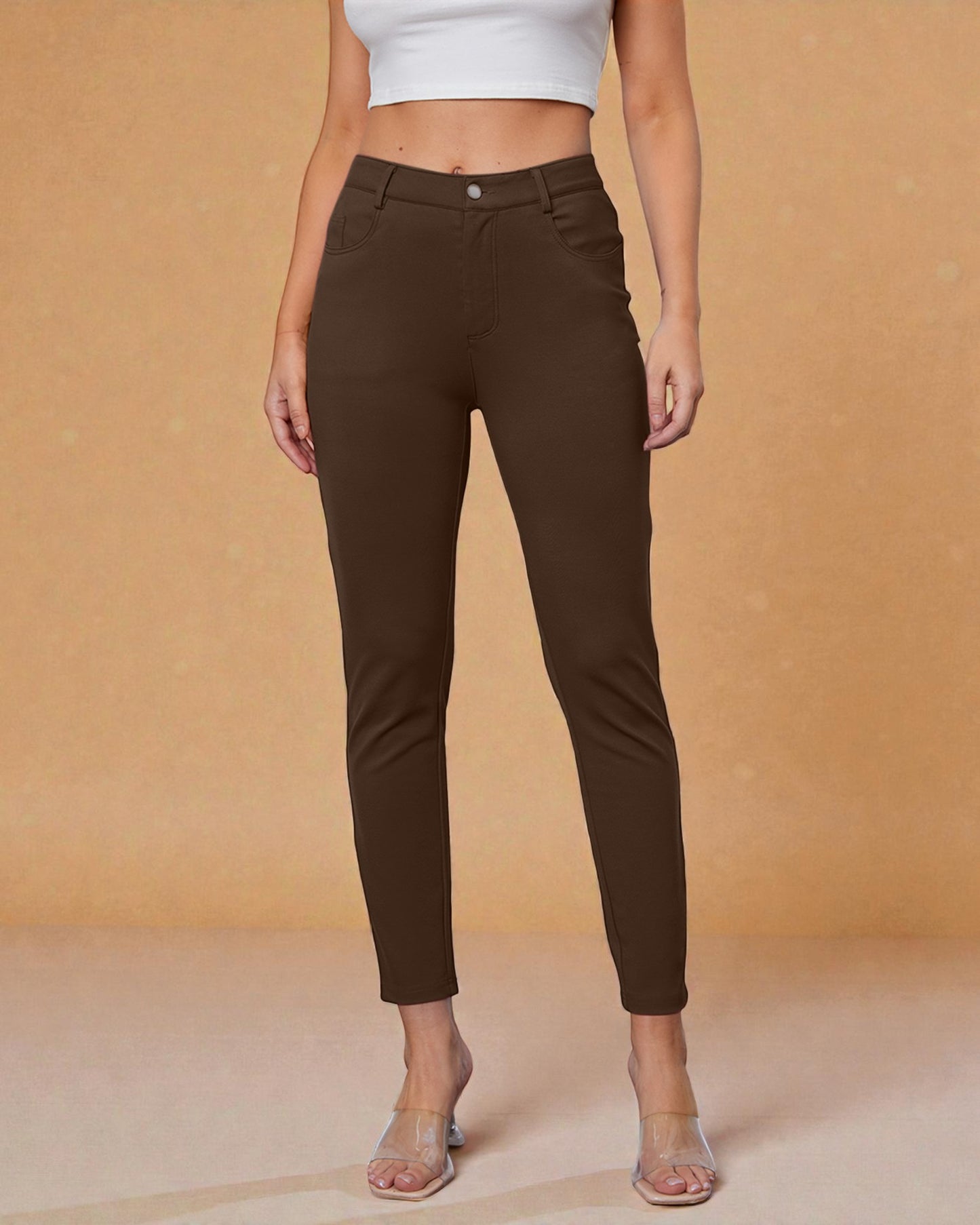 Brown pants worn by a person on a beige background