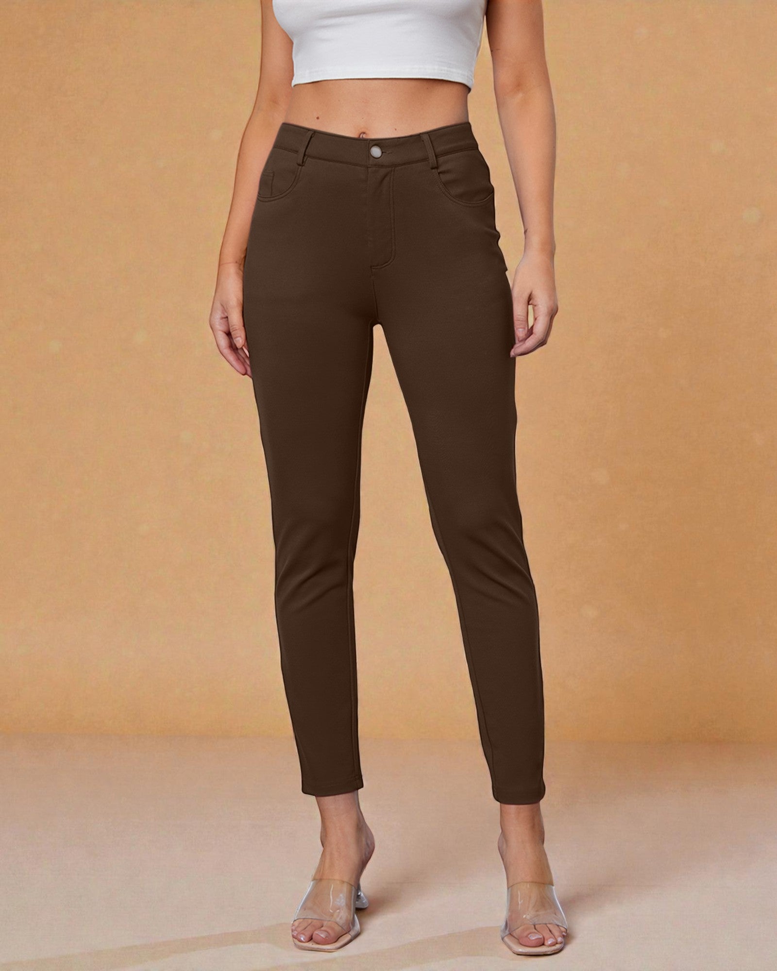 Brown pants worn by a person on a beige background