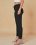 Black pants worn by a person on a beige background