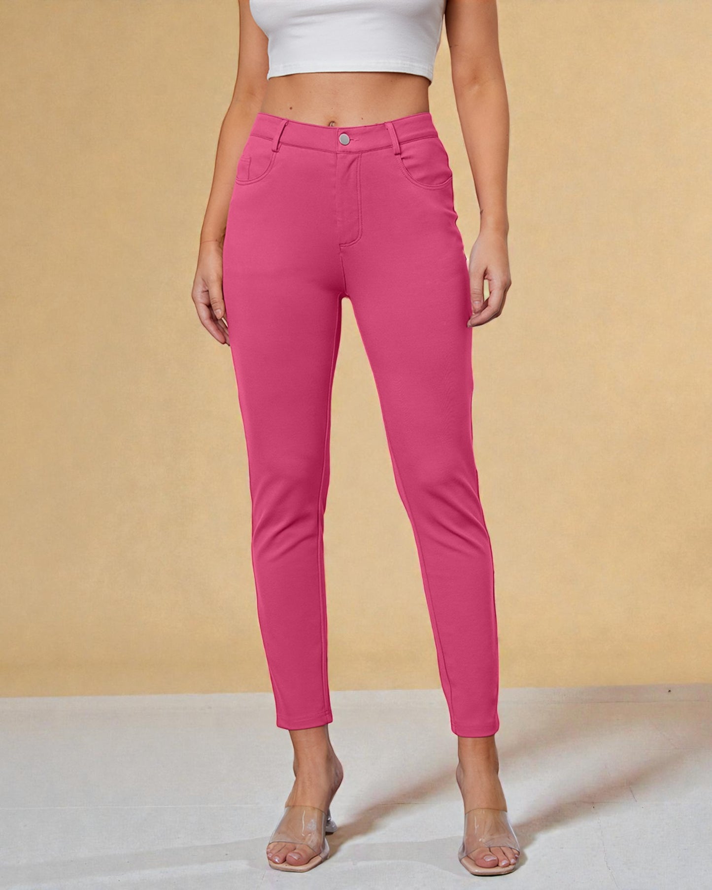 Person wearing bright pink pants against a beige background