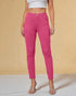 Person wearing bright pink pants against a beige background