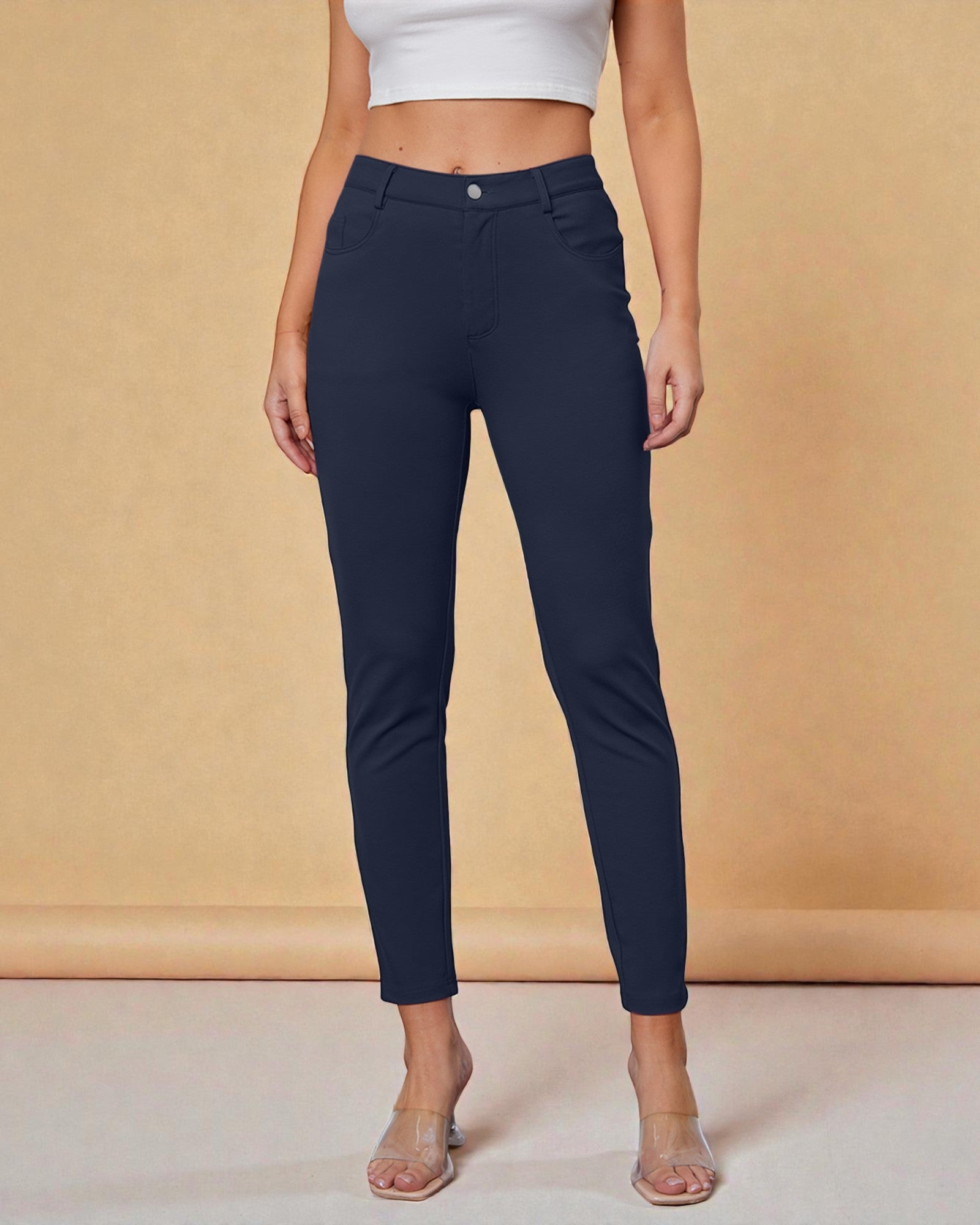 Navy blue pants worn by a person on a beige background