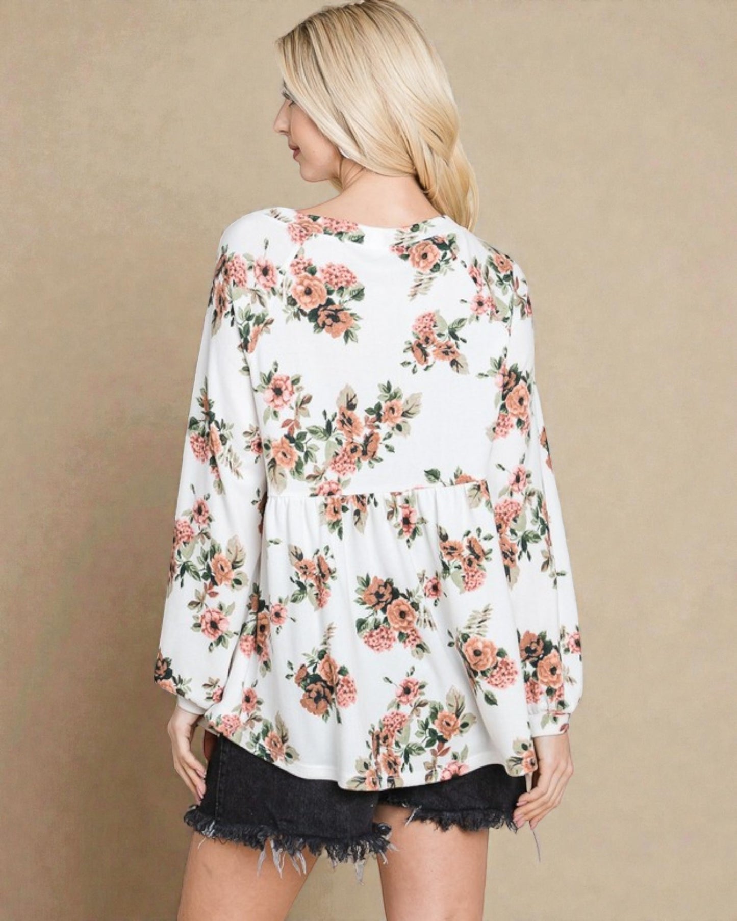 Woman wearing a floral blouse with a beige background