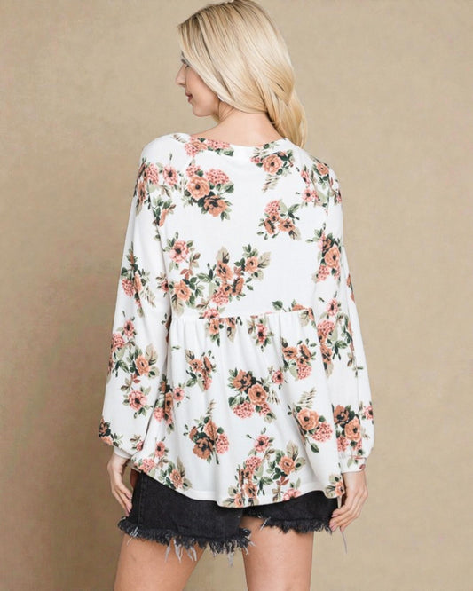 Woman wearing a floral blouse with a beige background