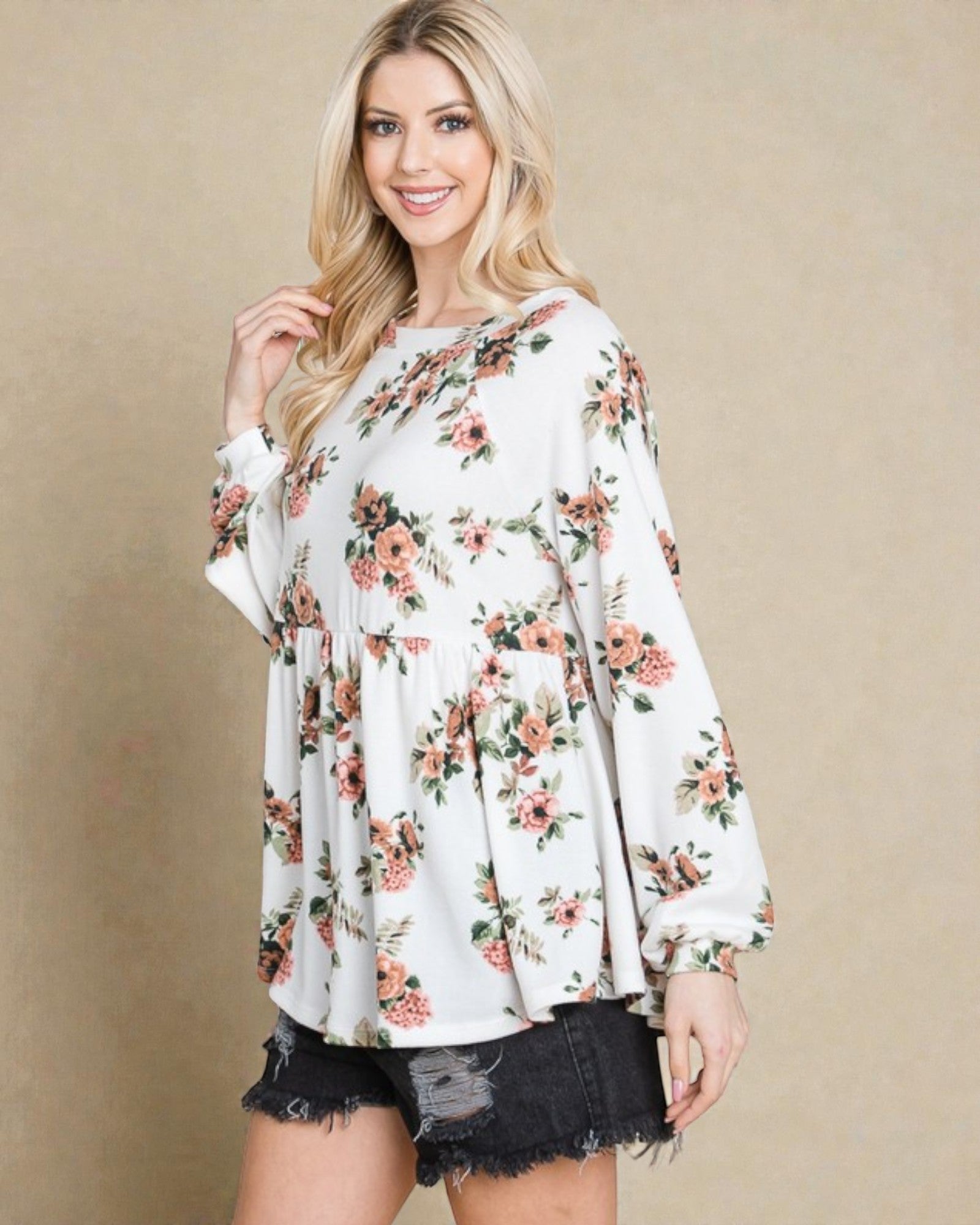 Woman wearing a floral blouse against a beige background