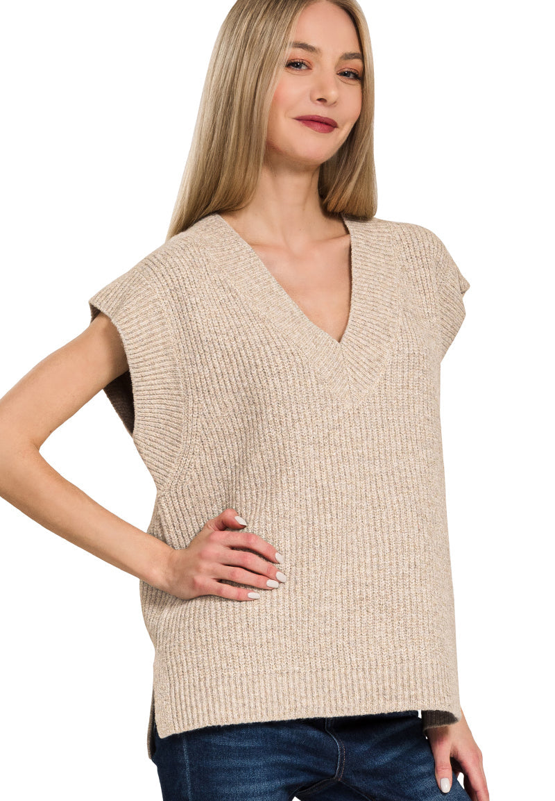Woman wearing a beige sleeveless sweater on a white background