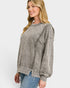 Woman wearing a gray sweatshirt and blue jeans on a white background