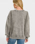 Person wearing a gray distressed jacket on a white background