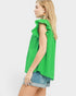 Woman wearing a green sleeveless top with ruffled details on a white background