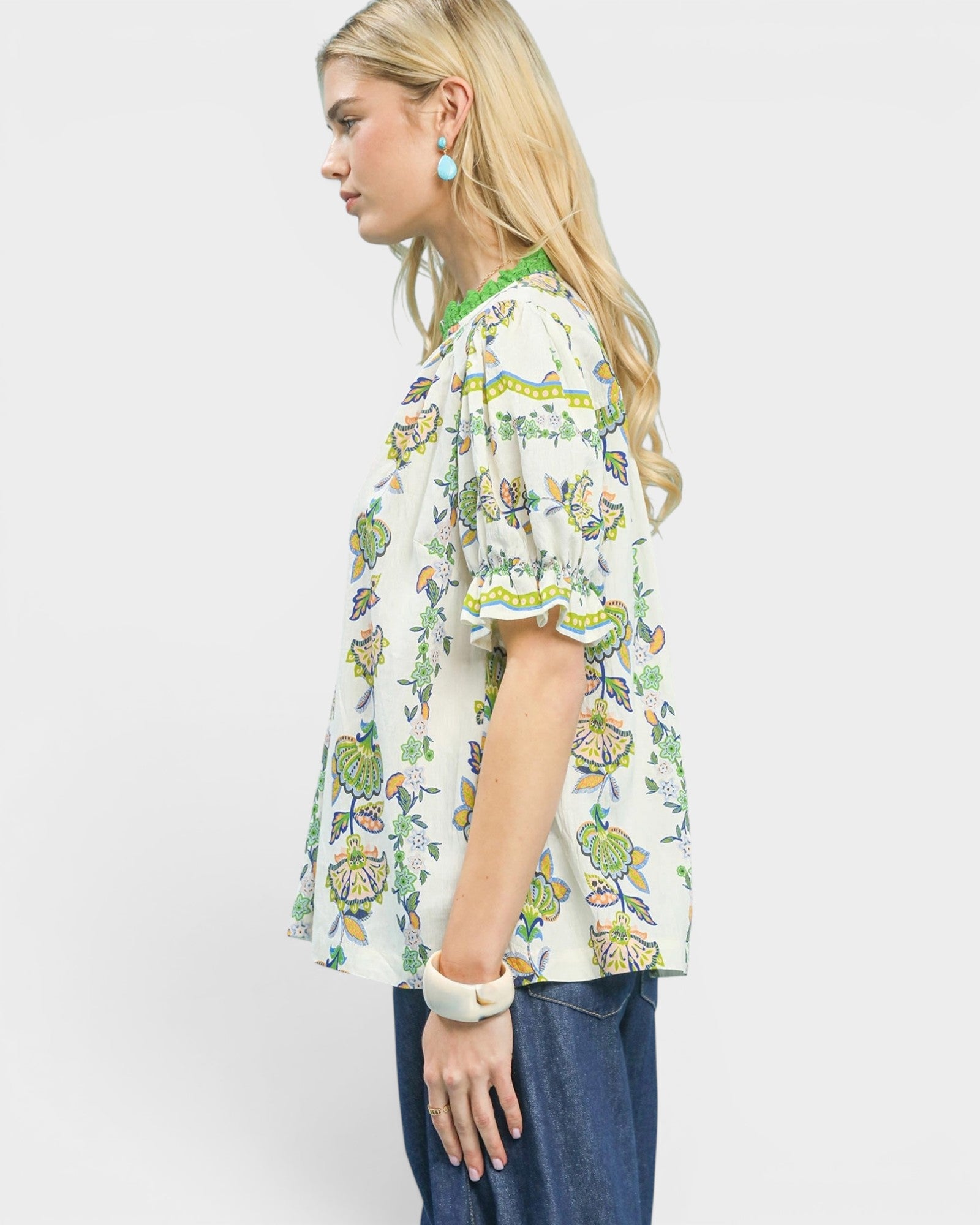 Woman wearing a floral blouse with a plain background