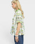 Woman wearing a floral blouse with a plain background