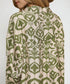 Green and beige patterned shirt on a plain background