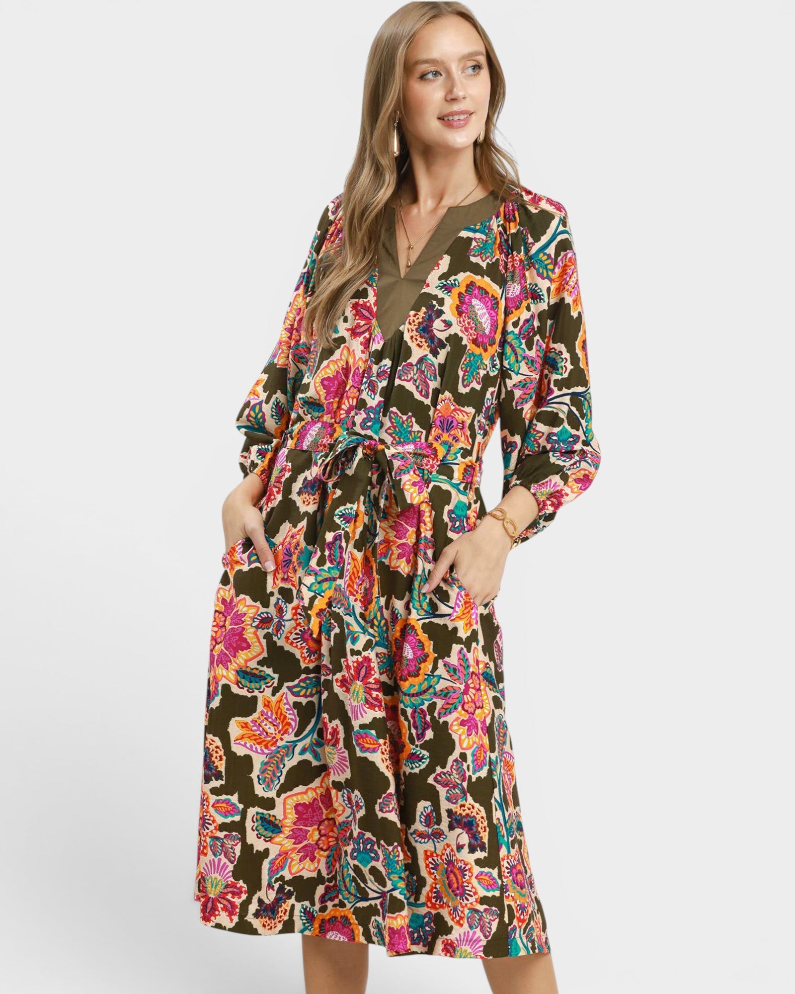 Woman wearing a colorful floral dress on a white background
