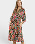 Woman wearing a colorful floral dress on a white background