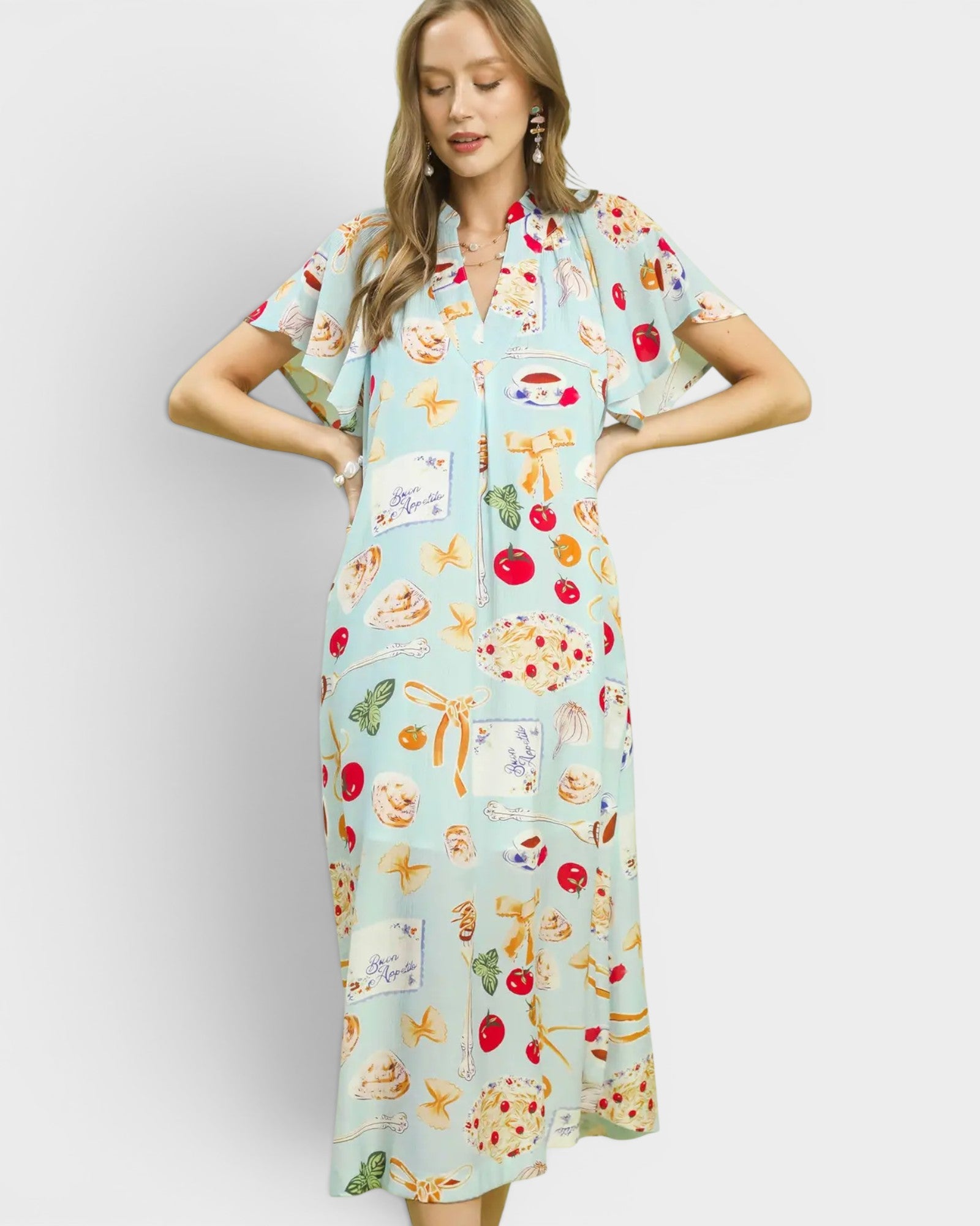 Woman wearing a colorful dress with food print on a white background