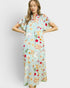 Woman wearing a colorful dress with food print on a white background