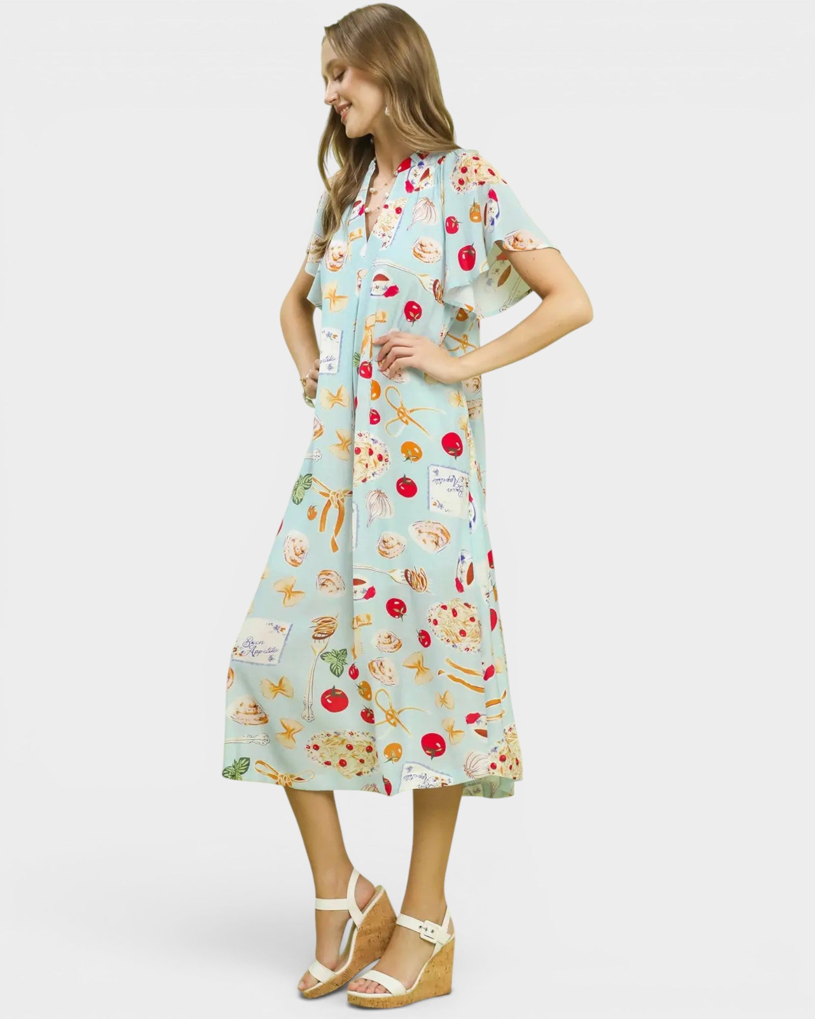 Woman wearing a colorful dress with a pattern on a white background
