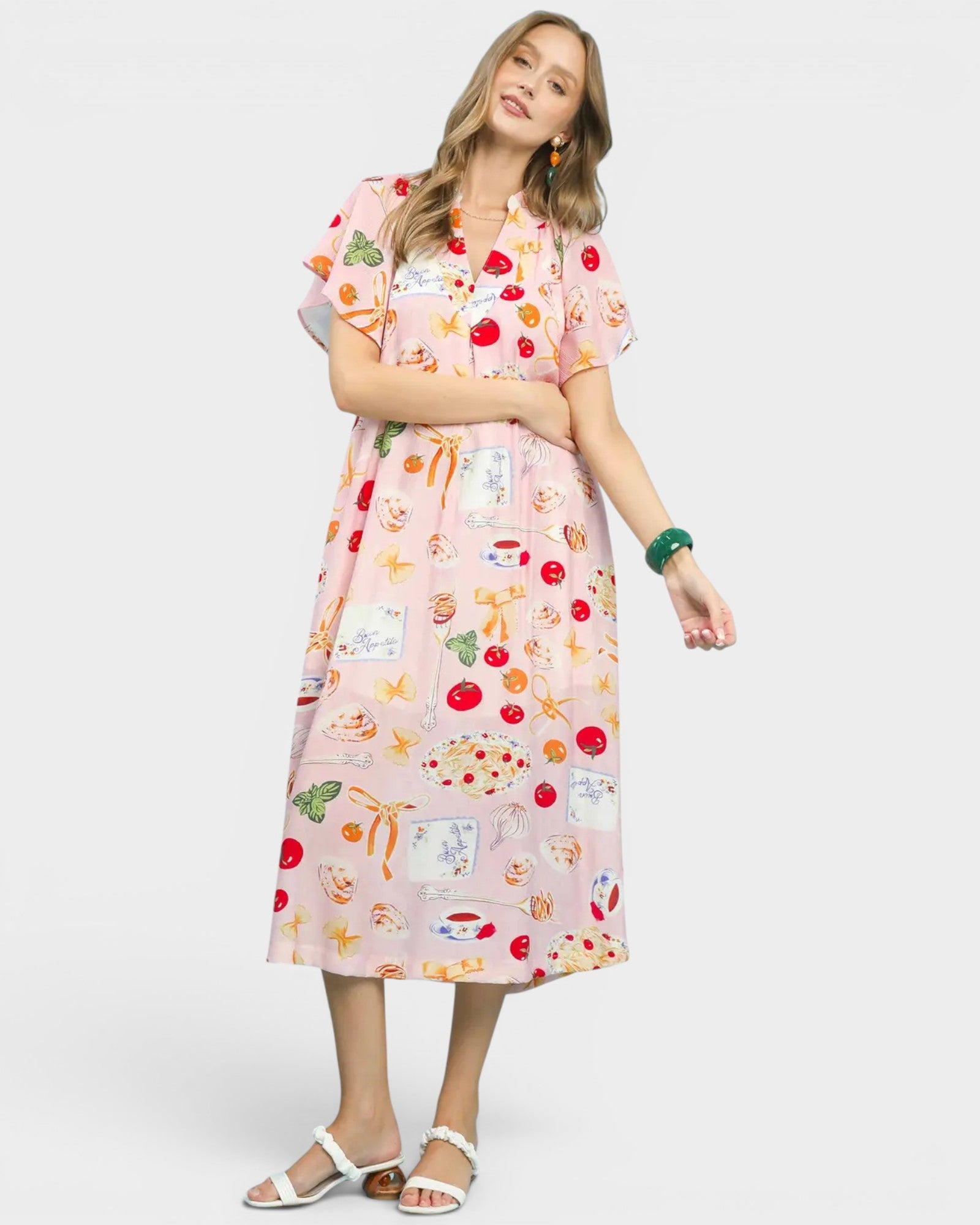 Woman wearing a colorful dress with a pattern on a white background