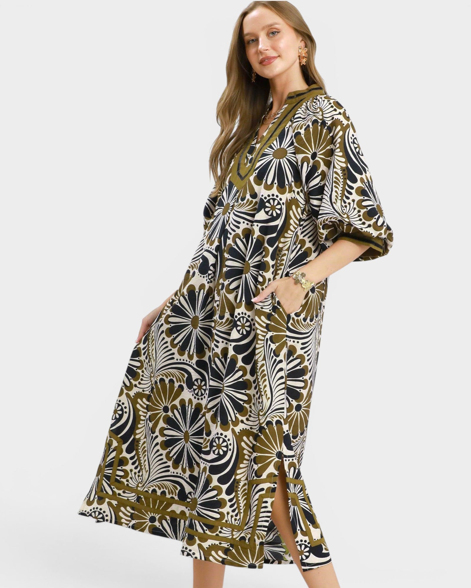 Woman wearing a patterned dress on a white background