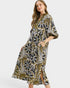 Woman wearing a patterned dress on a white background
