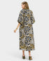 Woman wearing a patterned dress on a white background