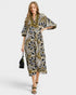 Woman wearing a patterned dress on a white background