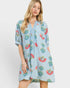 Woman wearing a light blue floral dress on a white background