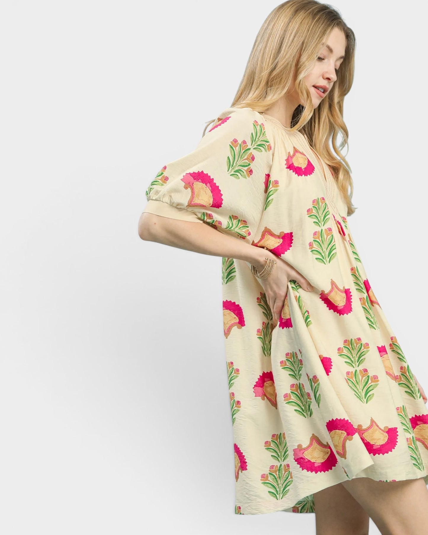 Woman wearing a floral dress with a white background