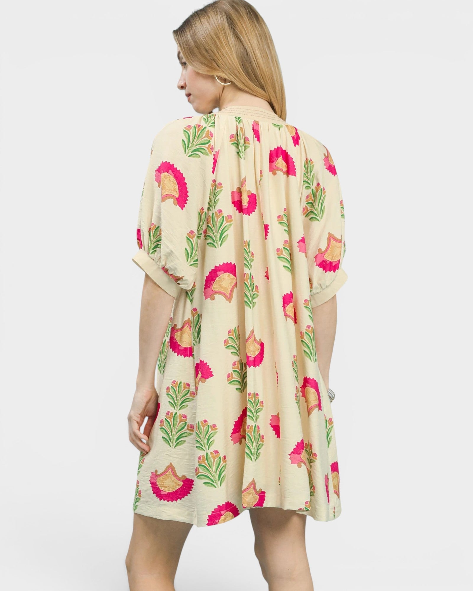 Woman wearing a floral dress with a white background
