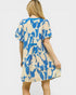 Woman wearing a blue and beige patterned dress on a white background