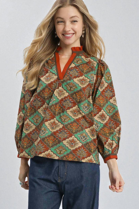 Woman wearing a patterned shirt with a plain background