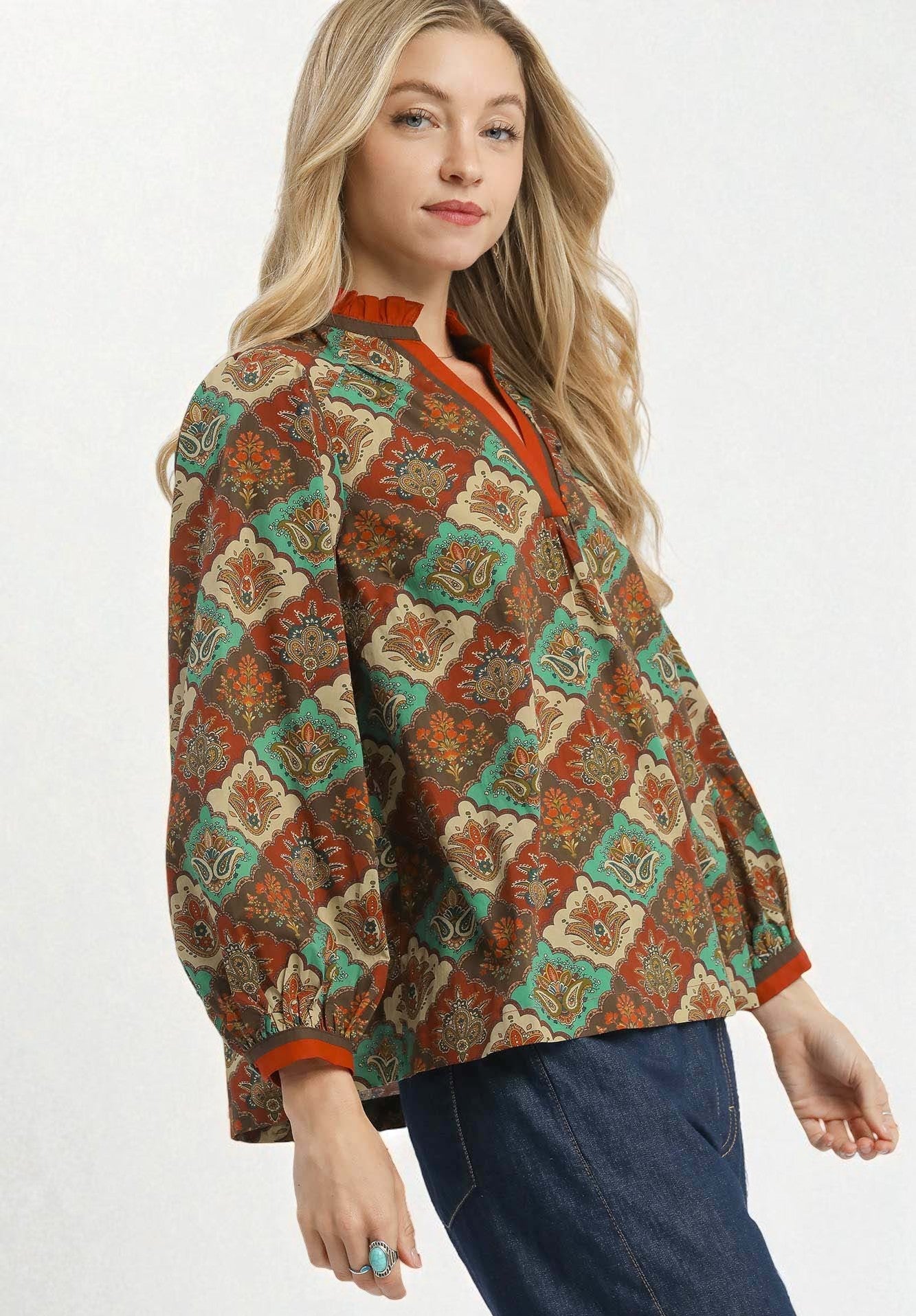 Woman wearing a patterned jacket on a white background