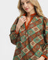 Woman wearing a patterned blouse with a white background