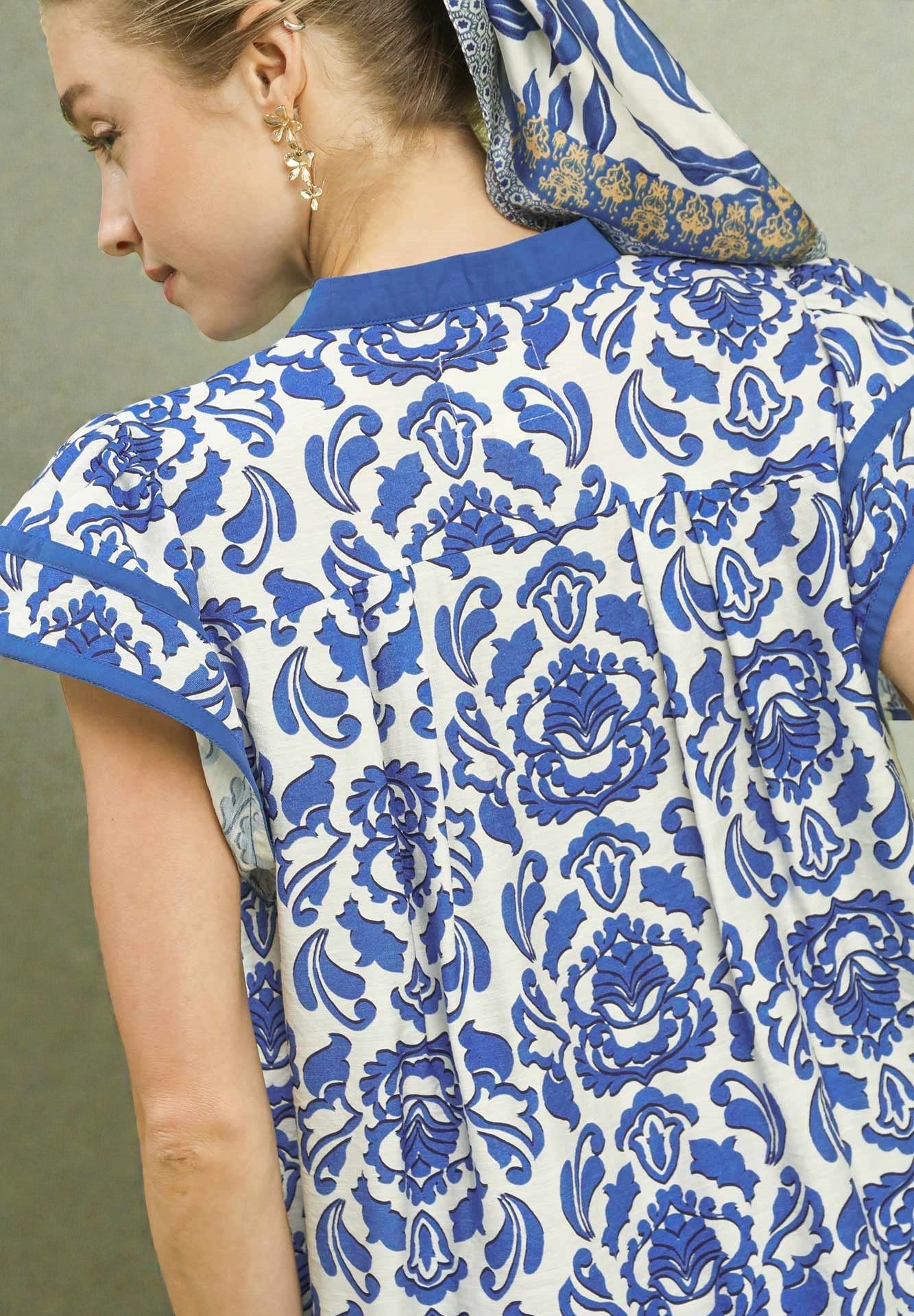 Close-up of a person wearing a blue and white patterned garment with a hood.