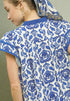 Close-up of a person wearing a blue and white patterned garment with a hood.