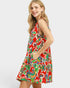 Woman wearing a colorful floral dress on a white background